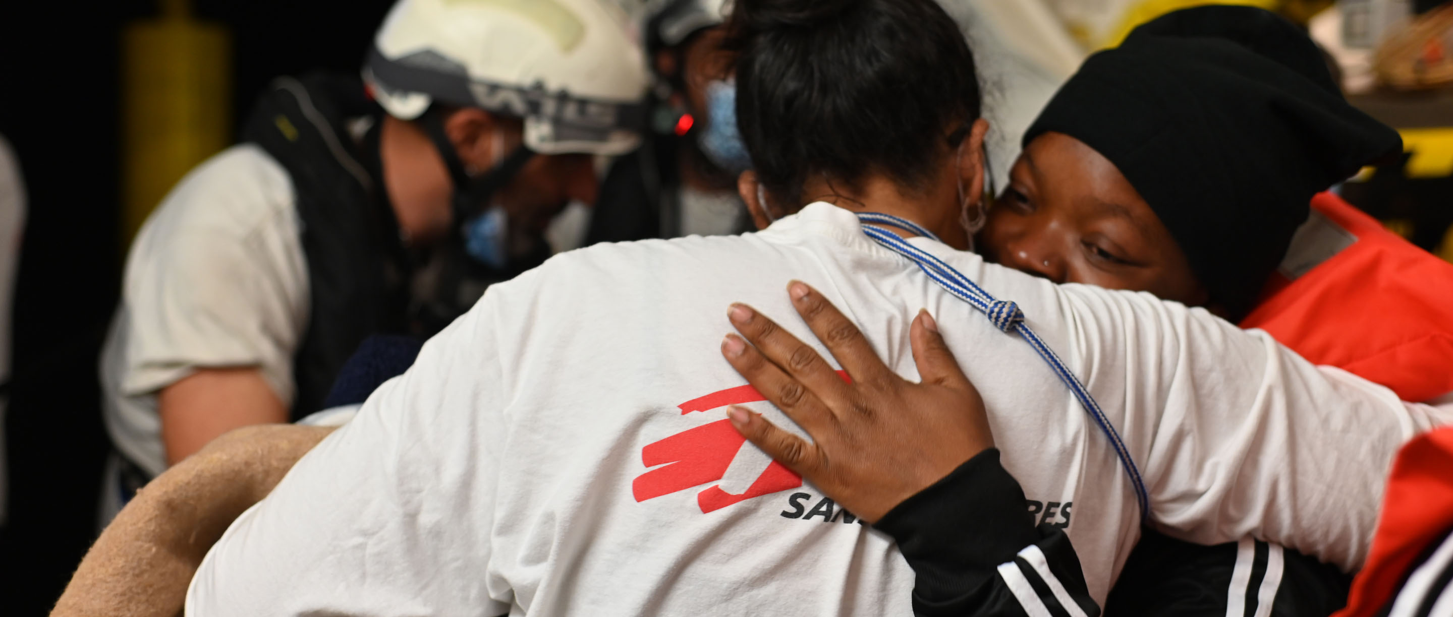 MSF Principles and Commitment ​  Image divider – MSF staff embracing a patient