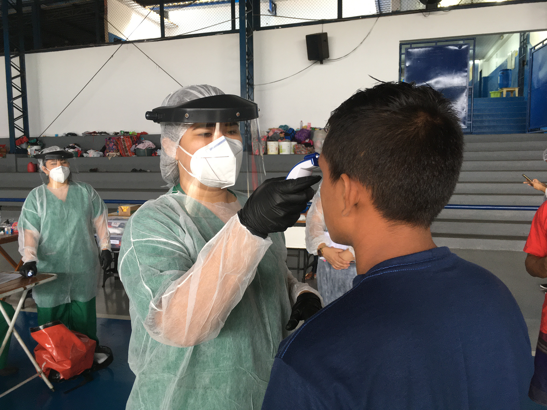 An MSF nurse takes the body temperature of a patient from the Warao people (indigenous group from Venezuela) at a shelter in Manaus, Brazil. © MSF 