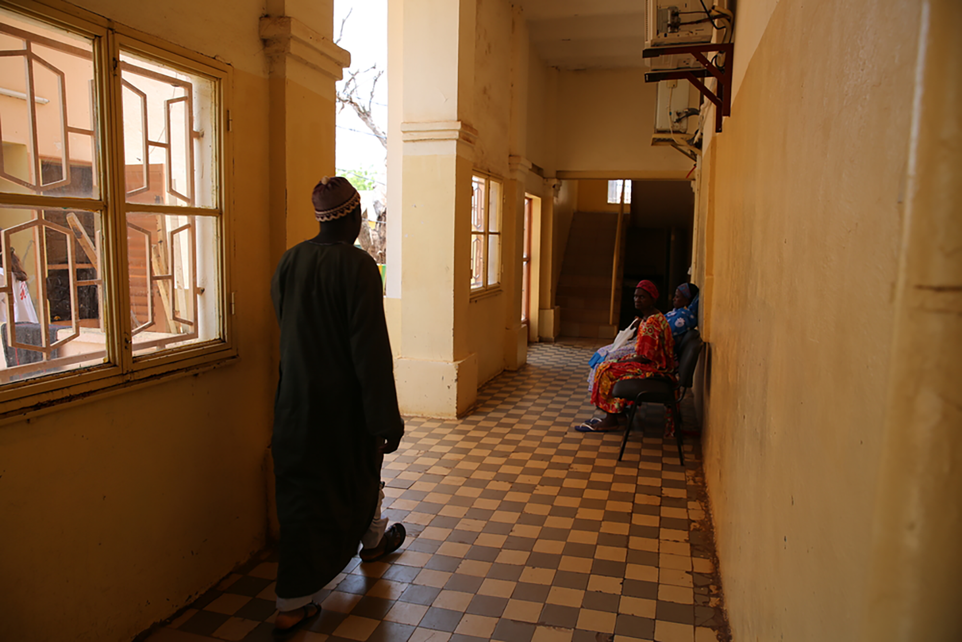 A man walks down a corridor at the Point G University hospital in Bamako. Mali, September 2019. © Mohammad Ghannam/MSF